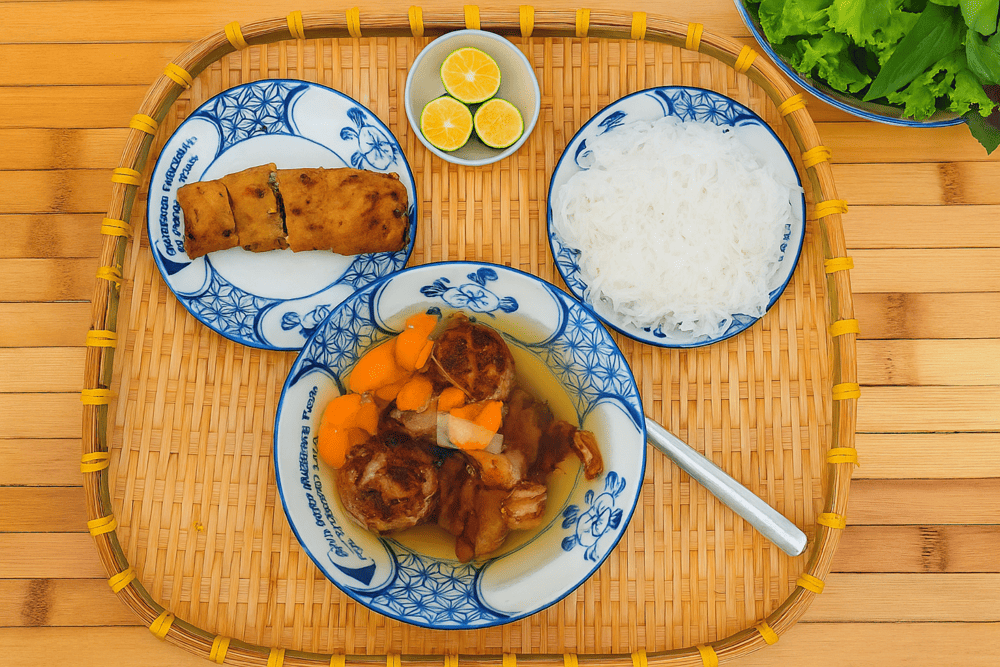 The special bun cha set includes grilled pork served in a sweet and tangy fish sauce, accompanied by a crispy fried spring roll
